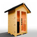 Medical Saunas Nature 5 Outdoor Infrared Sauna front view angled slightly right and upward, view through the windows to the warmly lit inside including partial inside ceiling and floor